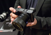 Sony a6500 Review man holding a Sony a6500 digital camera