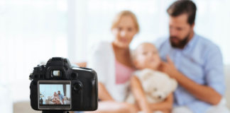 Best Nikon lens for family portraits family using a Nikon camera to take a family portrait