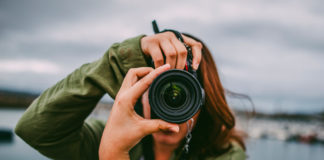 Best DSLR Cameras Under $1,000 in 2025: Expert Buying Guide A young woman using a DSLR camera