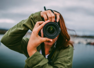 Best DSLR Cameras Under $1,000 in 2025: Expert Buying Guide A young woman using a DSLR camera