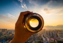 Best Nikon D5600 Lenses for Photography Hand holding camera lens