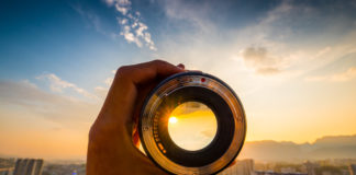 Best Nikon D5600 Lenses for Photography Hand holding camera lens