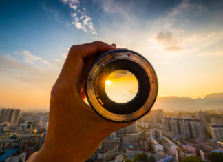 Best Nikon D5600 Lenses for Photography Hand holding camera lens