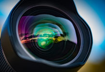 Best lens for sony a6500 Cameras A seascape sunset reflected in the large front element of a 15mm wide angle lens, with the coloured lens element coatings enhancing the effect.