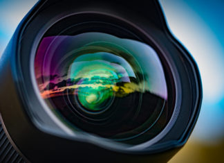 Best lens for sony a6500 Cameras A seascape sunset reflected in the large front element of a 15mm wide angle lens, with the coloured lens element coatings enhancing the effect.