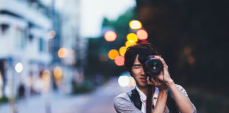 Best cameras for night photography in 2023 A young Japanese man is taking photos at night in Tokyo