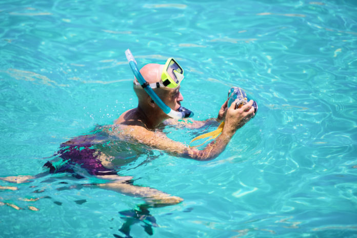 Underwater amateur photographer taking pictures