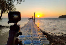 Best GoPro like Cameras in 2023 gopro alternative Action camera mounted on a tripod photograph the pier and sunrise on the beach