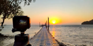 Best GoPro like Cameras in 2023 gopro alternative Action camera mounted on a tripod photograph the pier and sunrise on the beach