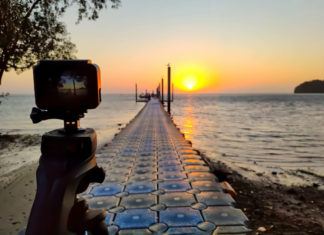Best GoPro like Cameras in 2023 gopro alternative Action camera mounted on a tripod photograph the pier and sunrise on the beach