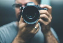 Best Cameras Under $700 in 2023 man using a digital camera worth $700 and pointing it