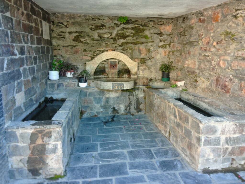 Kodak PIXPRO C1 sample photo of a stone fountain in deep shade
