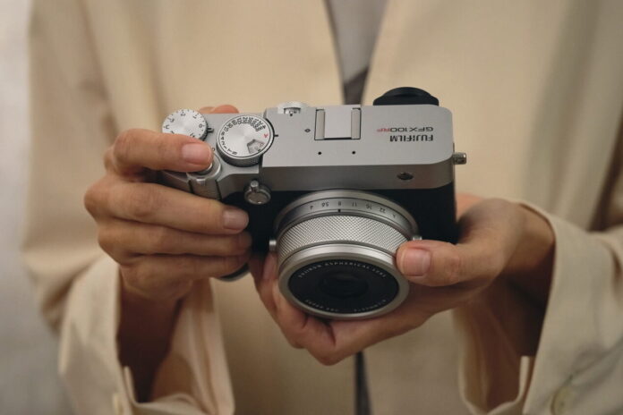 Fujifilm GFX100RF medium format camera Photographer holding the Fujifilm GFX100RF medium format camera
