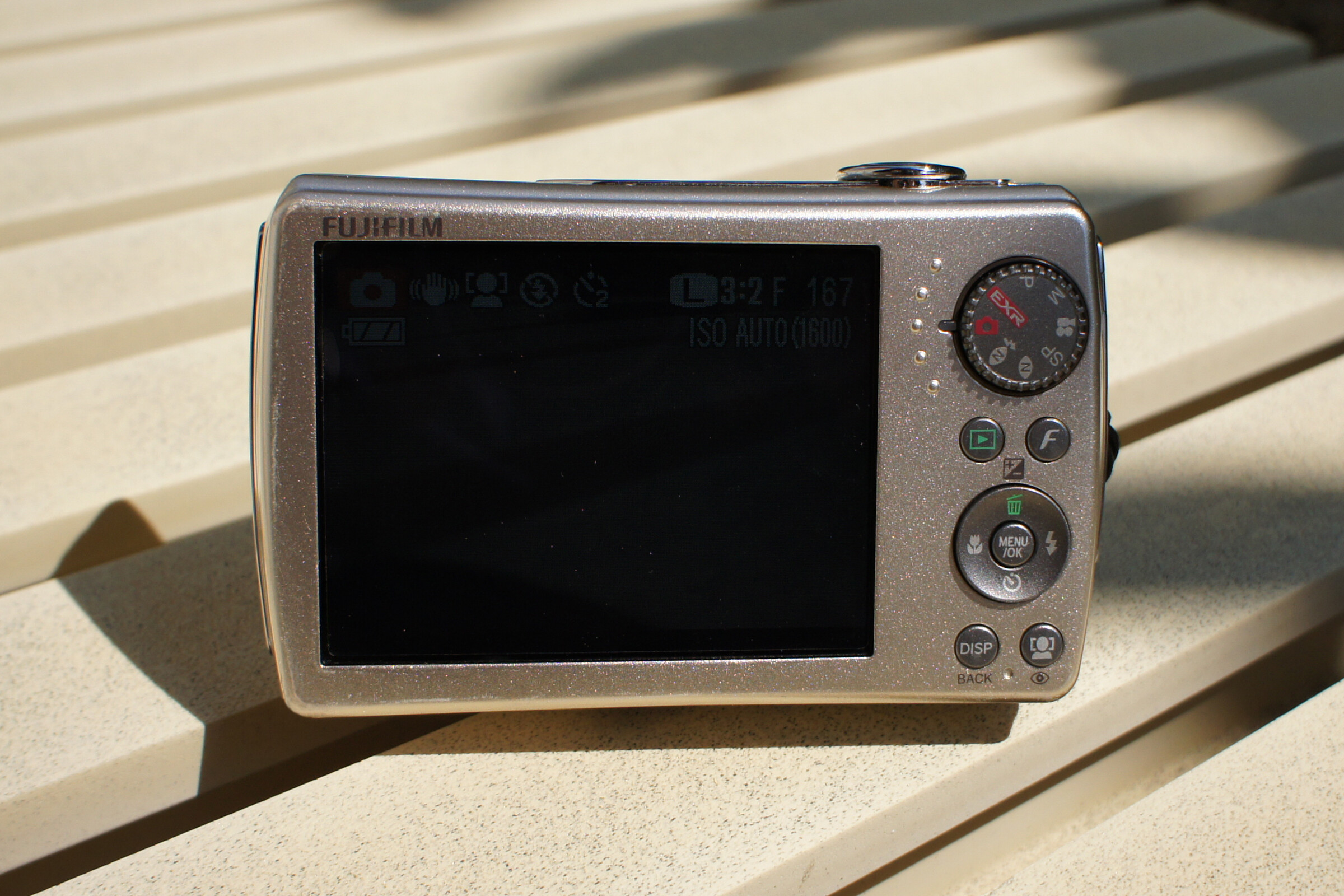 Rear of the silver Fujifilm FinePix F200EXR showing the EXR mode dial and fixed LCD